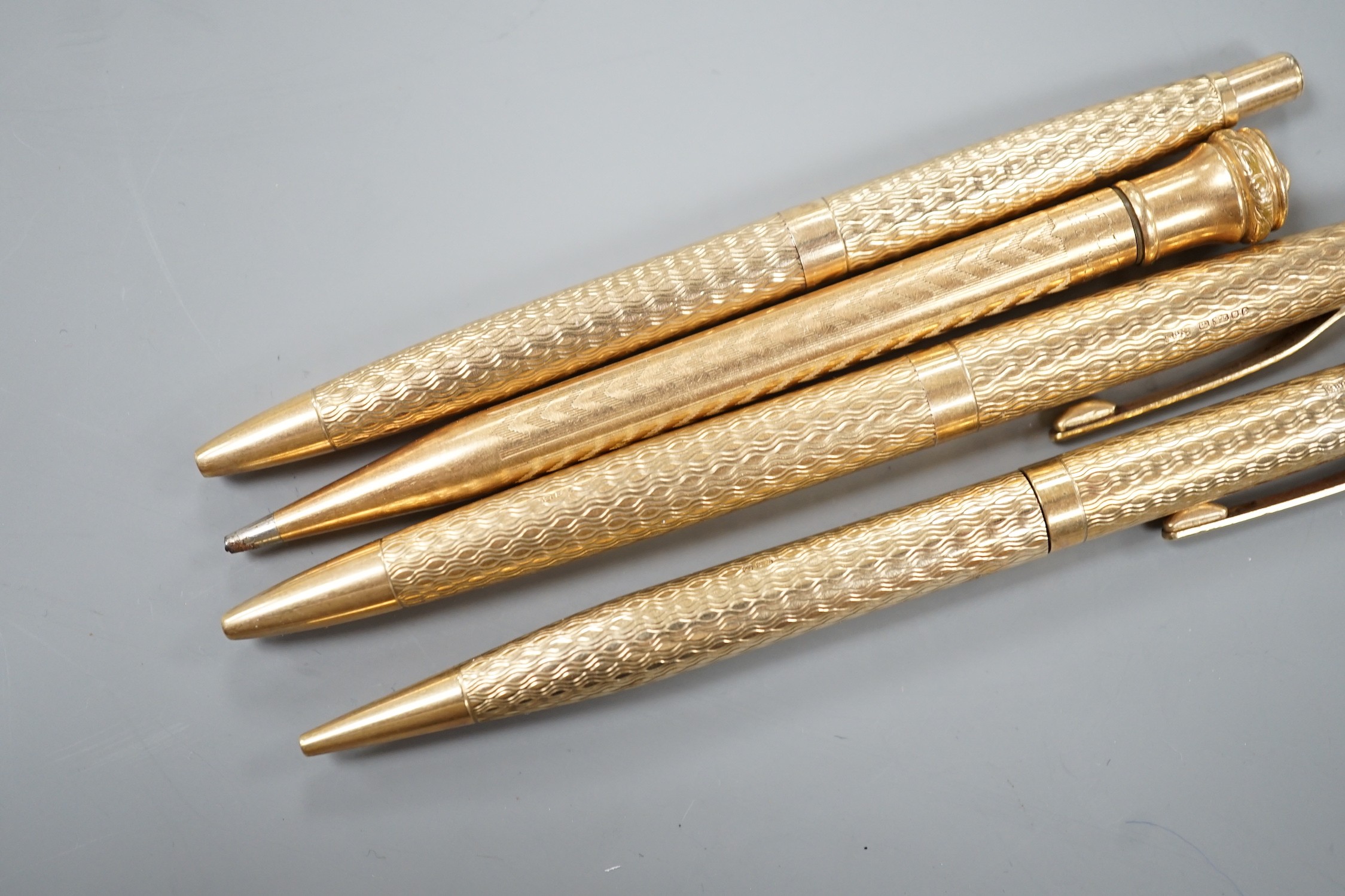 Three 9ct gold case ballpoint pens and a gold filled pen.